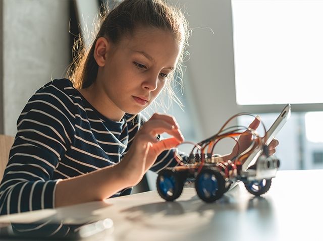 young girl with robotics model