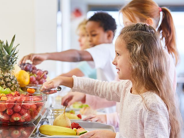 young student in line for fruit