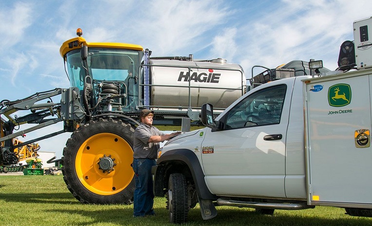 man with Hagie and Deere truck